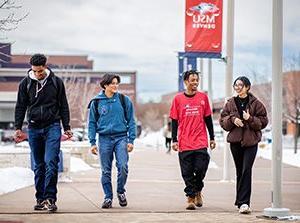 A group of students walking through a snowy Auraria Campus.